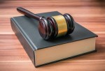 Wooden gavel on book. Justice and law concept.